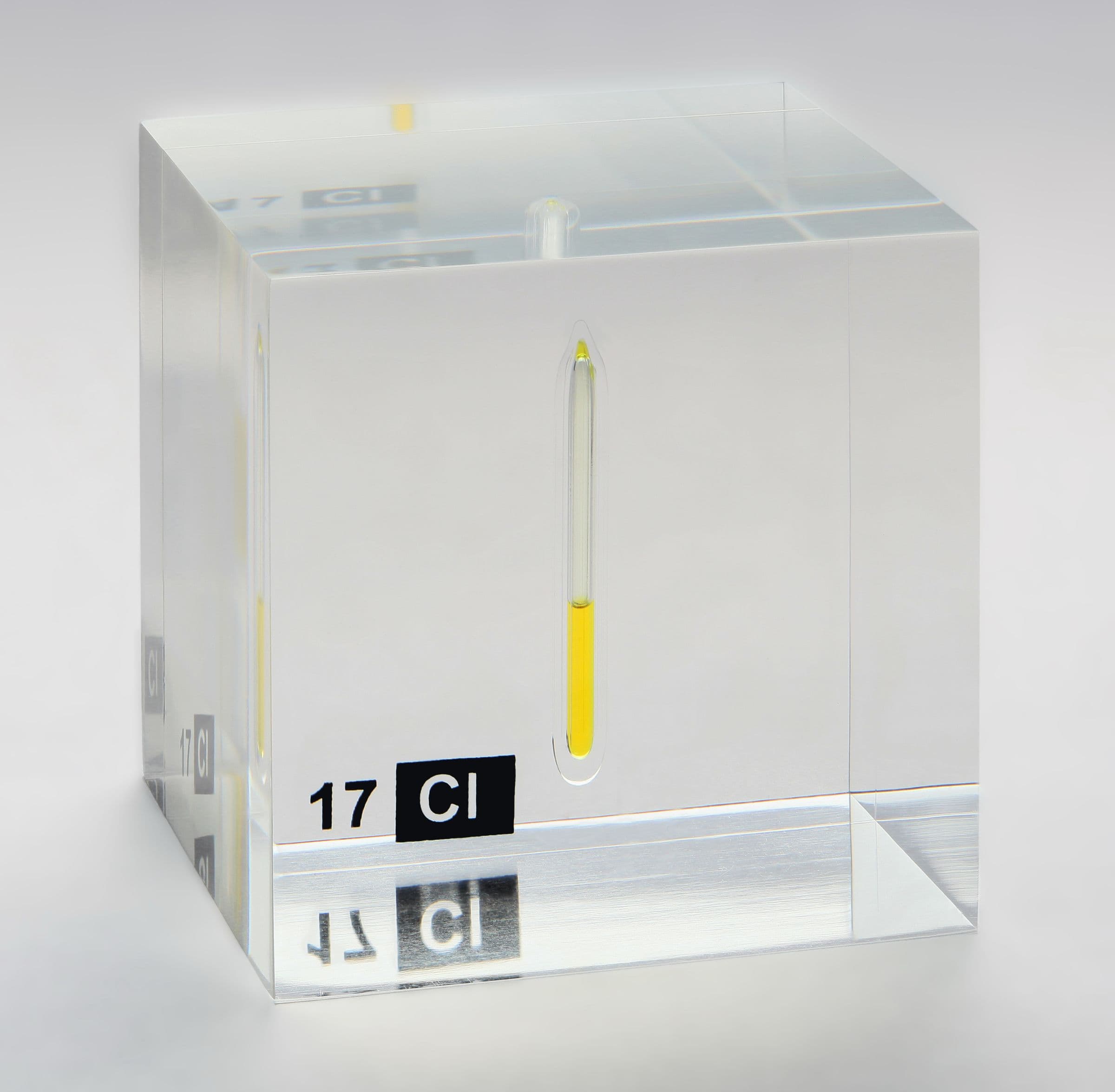 Glass ampoule of pale yellow liquid chlorine on a white ground