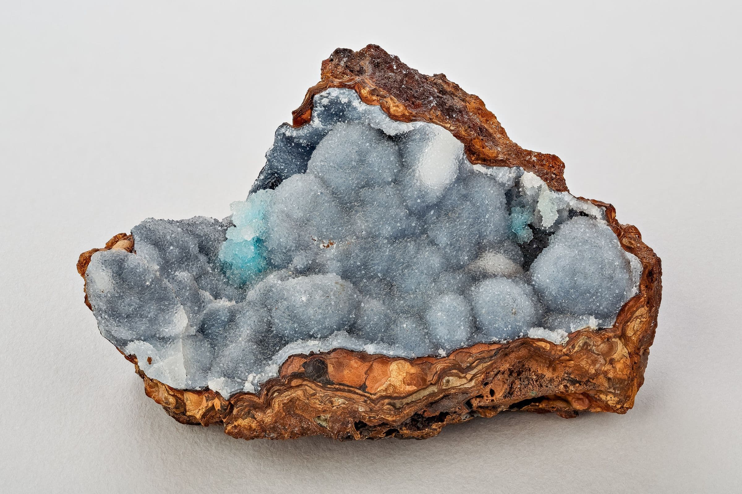 Geode lined with quartz crystals, photographed on white