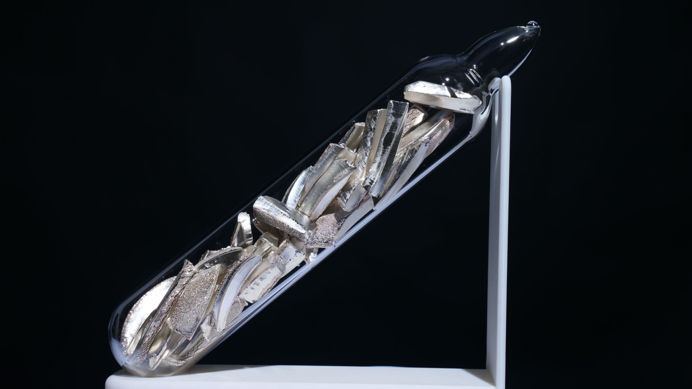 Purified lithium sealed under argon in a glass ampoule, on black