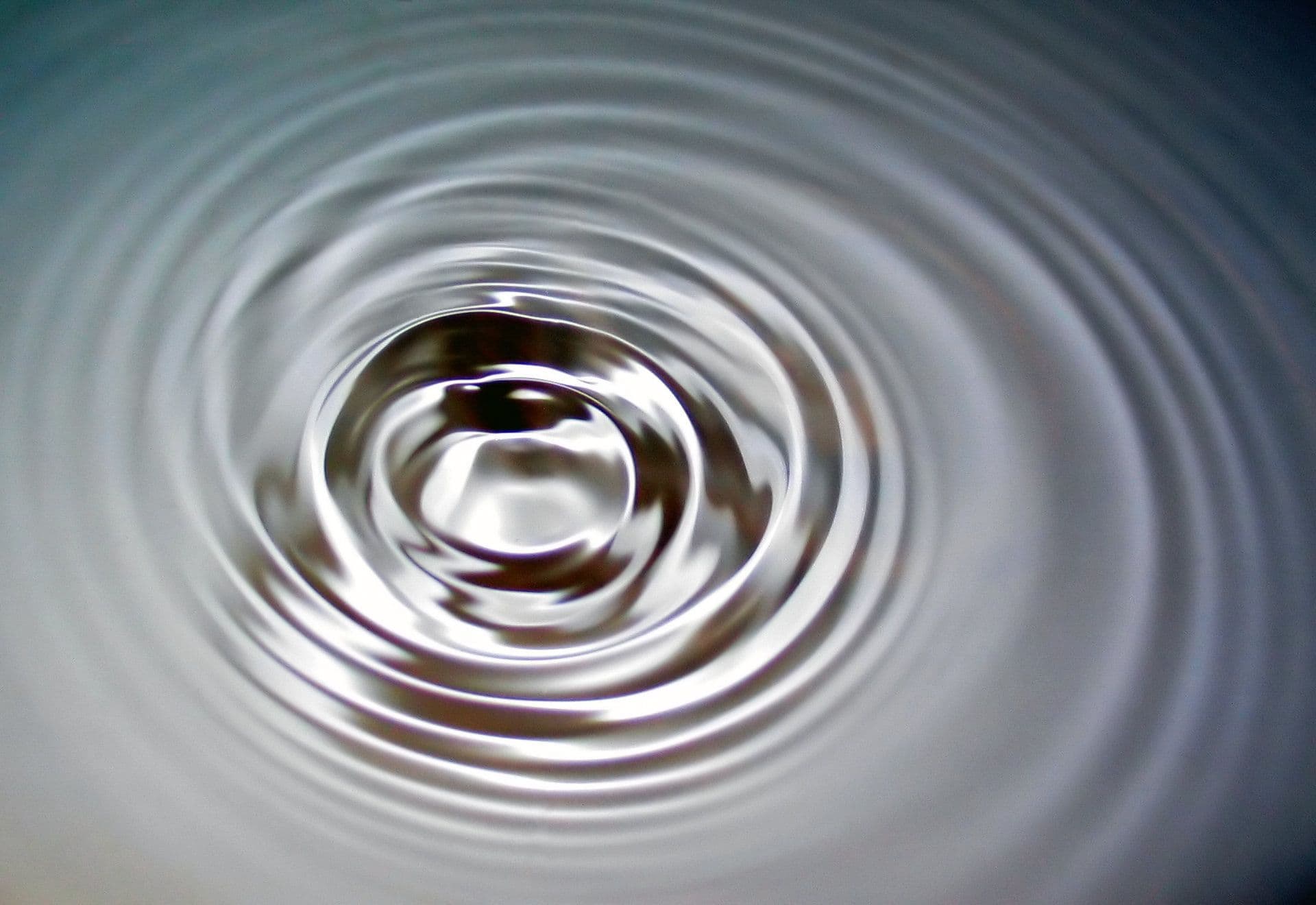 Concentric ripples spreading across still water